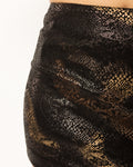 Close up of the black and gold suede-touch snake print fabric