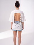 Back view of the Girl Code white chain back slogan t-shirt showing the open back cutout with silver chains
