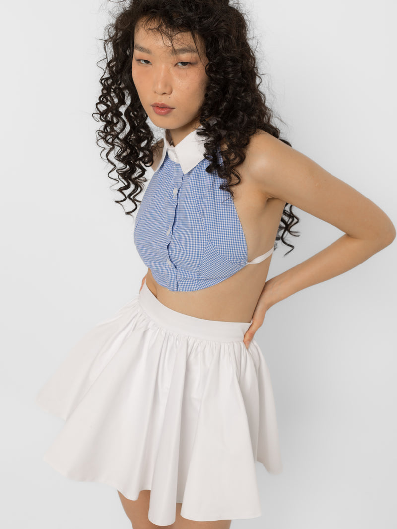 Model wearing Girl Code white cotton mini skirt with built-in shorts