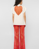 Model wearing Girl Code white heart cutout oversized t-shirt, back view showing red crystal tulle heart