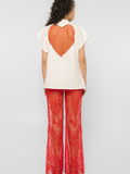 Model wearing Girl Code white heart cutout oversized t-shirt, back view showing red crystal tulle heart