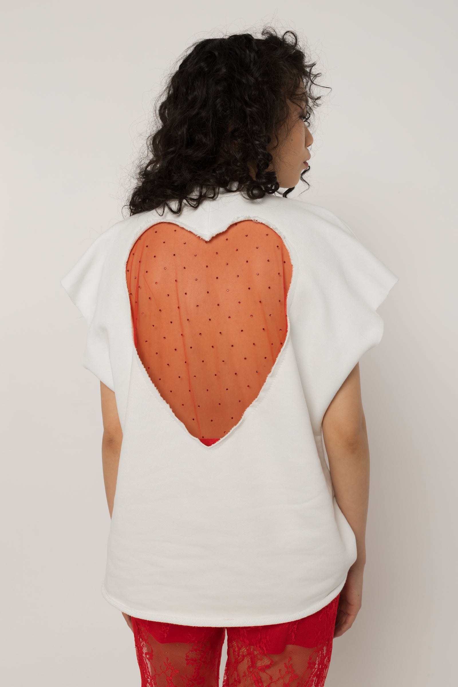 Model wearing Girl Code white heart cutout oversized t-shirt, front view