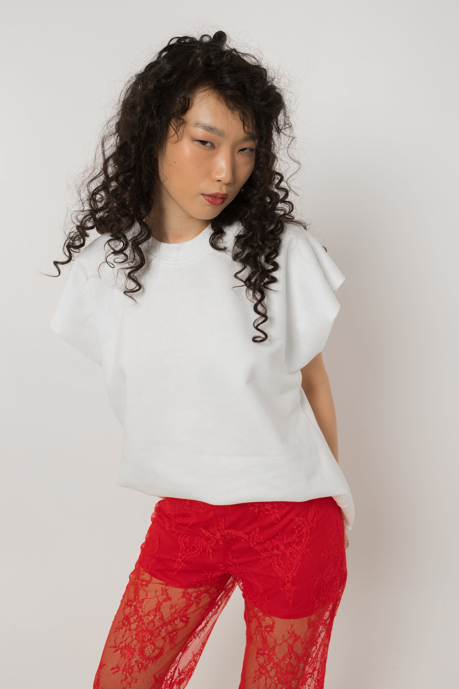 Close up of red crystals set into the tulle heart on the white cotton tee