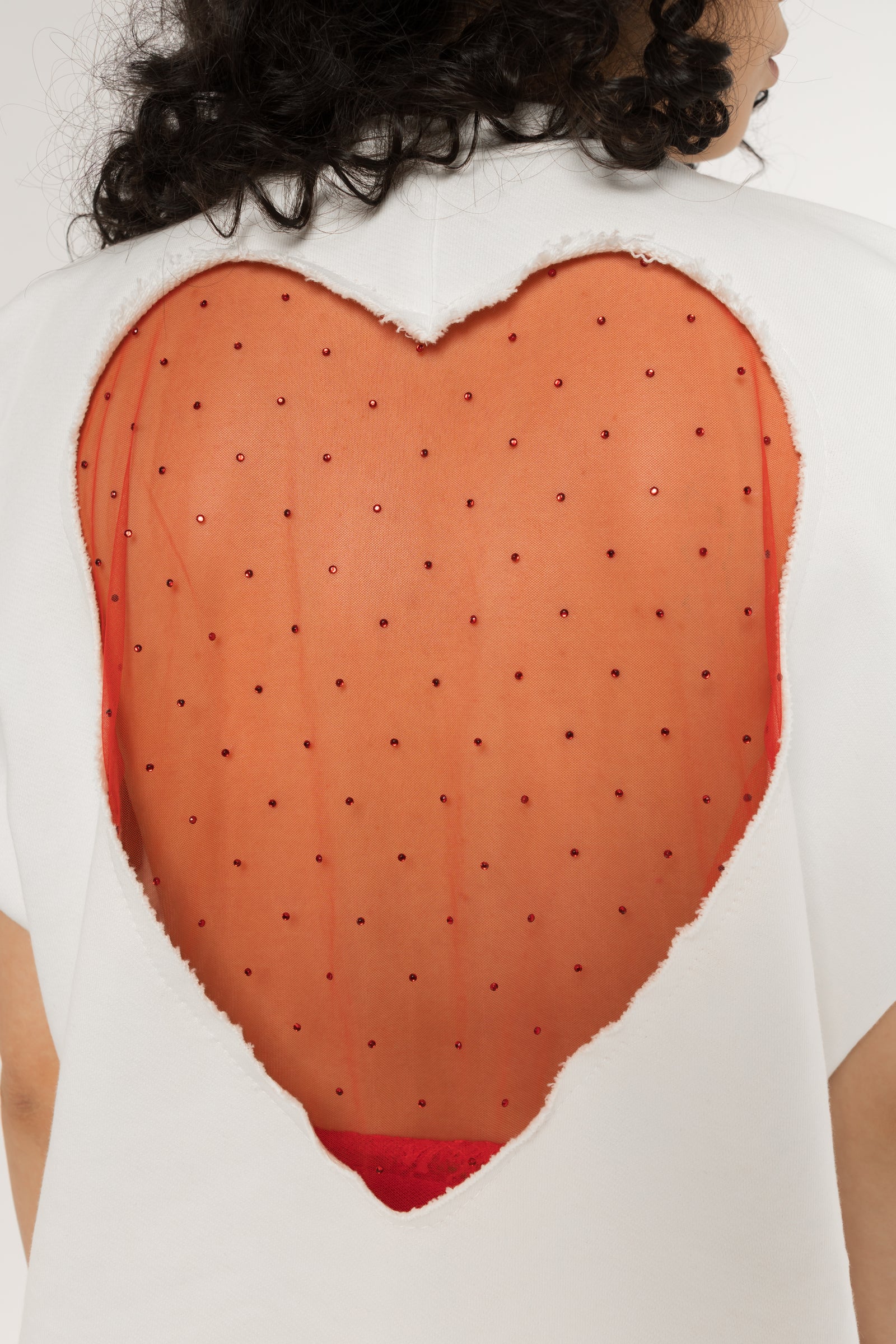 White oversized t-shirt with raw cut edges and wide dropped sleeves
