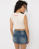 Close up of the steel rings on the chest cutout band of the Girl Code white pierced cutout crop top