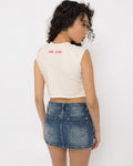 Close up of the steel rings on the chest cutout band of the Girl Code white pierced cutout crop top