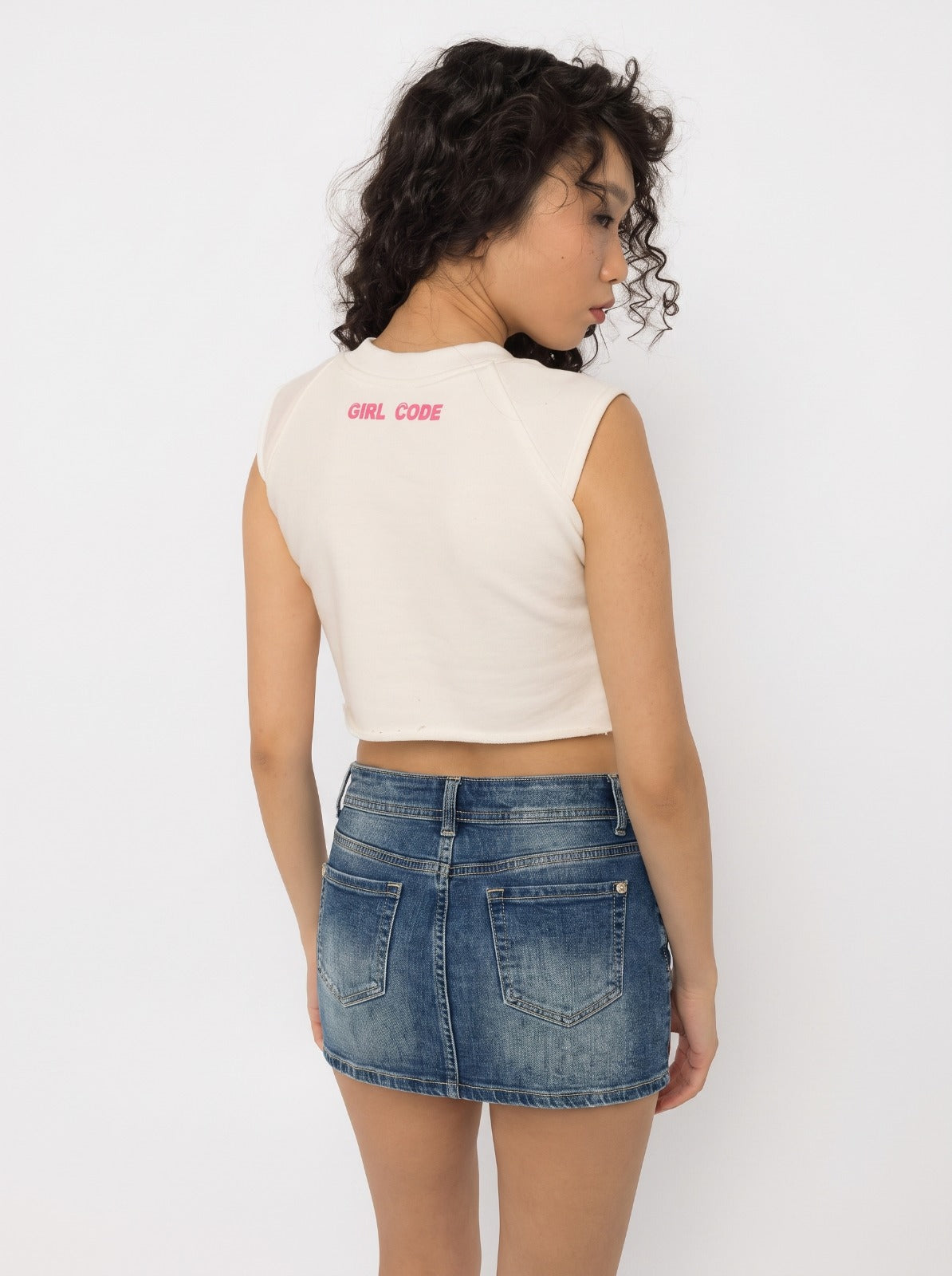 Close up of the steel rings on the chest cutout band of the Girl Code white pierced cutout crop top