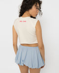 Chest cutout of the white crop top set with silver steel rings, close view